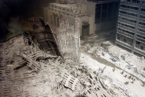 A group of firefighters walk amid rubble near the base of the destroyed south tower of the World Trade Center in New York in this file photo from September 11, 2001. This year's anniversary of the September 11 attacks in New York and Washington will echo the first one, with silence for the moments the planes struck and when the buildings fell, and the reading of 2,792 victims' names. REUTERS/Peter Morgan-Files HB/